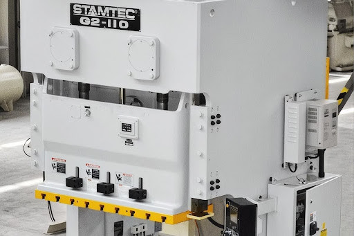 Stamtec G2-110 mechanical press, a white gap-frame model on a manufacturing shop floor
