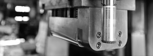 Sheet metal stamping tool die and tandem stamping system at an automotive manufacturing facility, illustrating how a stamping press and die work together to form precision parts
